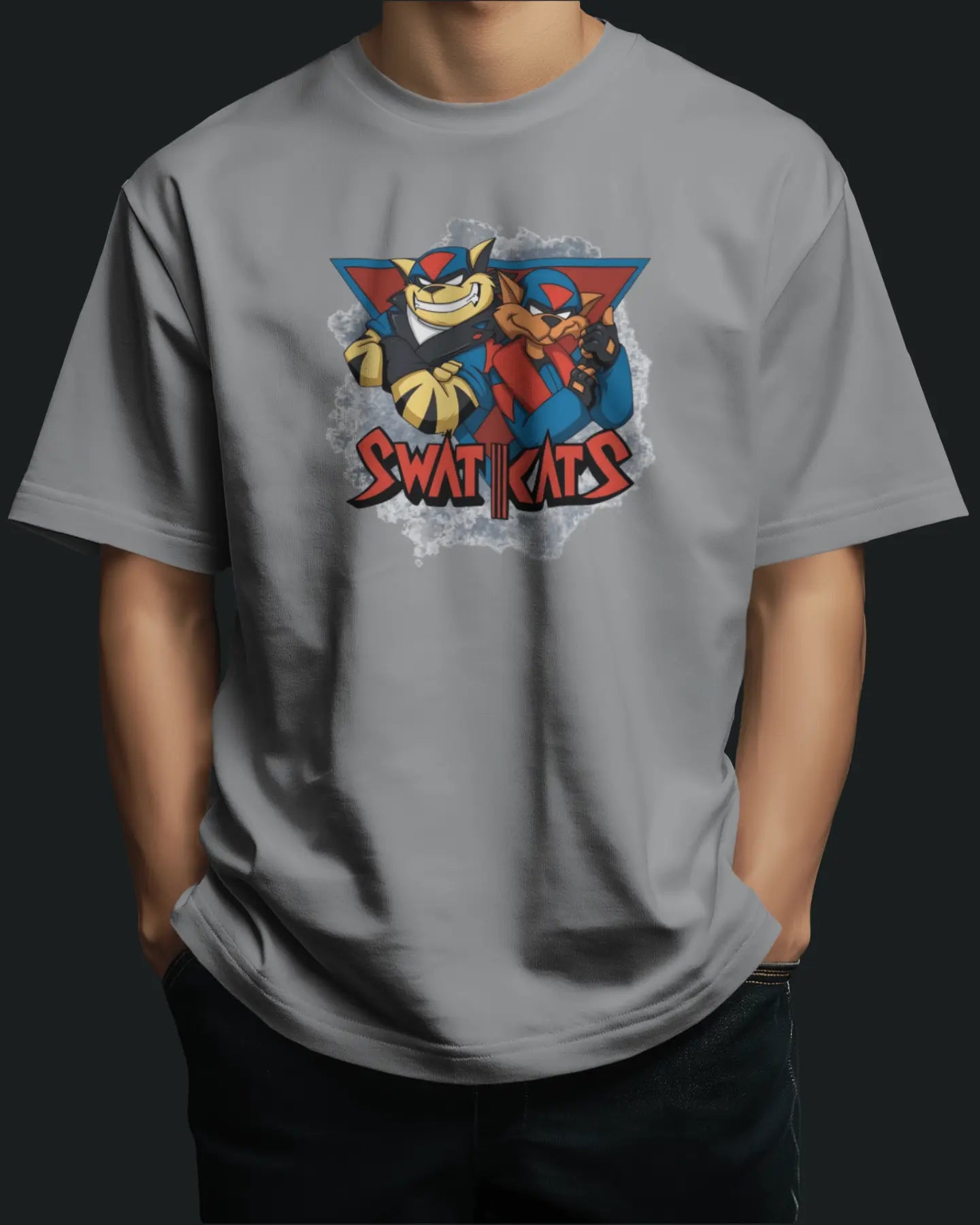 Person wearing a gray t-shirt with a colorful swat kats graphic design on a black background