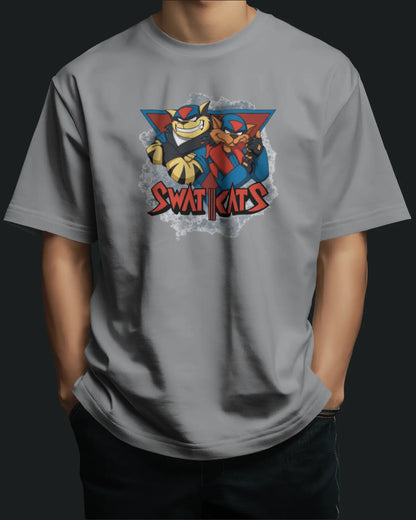 Person wearing a gray t-shirt with a colorful swat kats graphic design on a black background