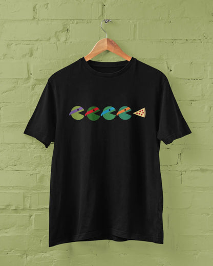 Black t-shirt with colorful graphic design on a green brick wall background