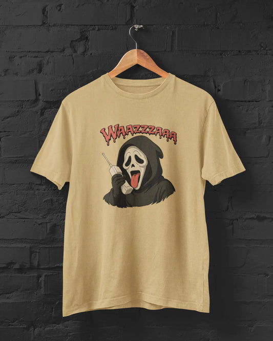 Beige t-shirt with a graphic design of a cartoonish grim reaper and 'WAZZZAAR' text on a black brick wall background.