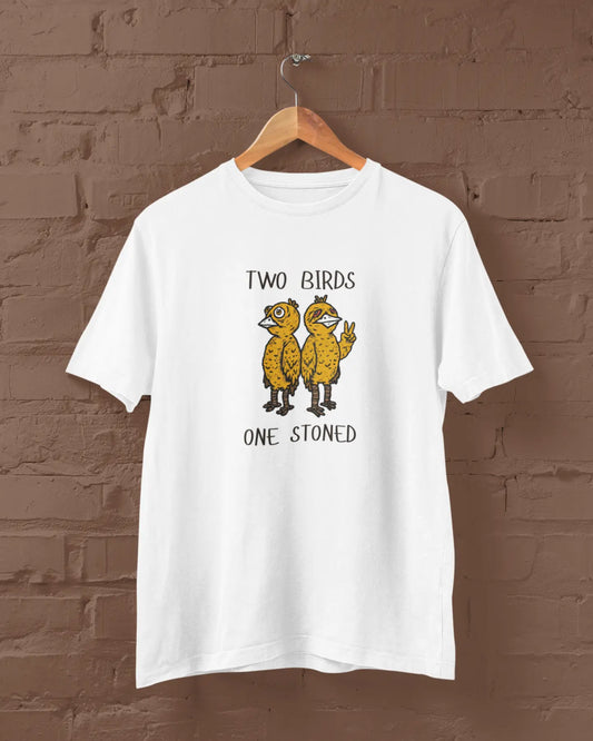 White t-shirt with 'Two Birds One Stoned' graphic on a brown brick wall background