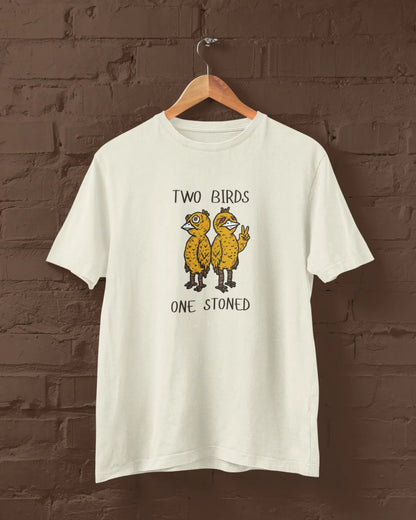 Off White t-shirt with 'Two Birds One Stoned' graphic on a wooden hanger against a brick wall.