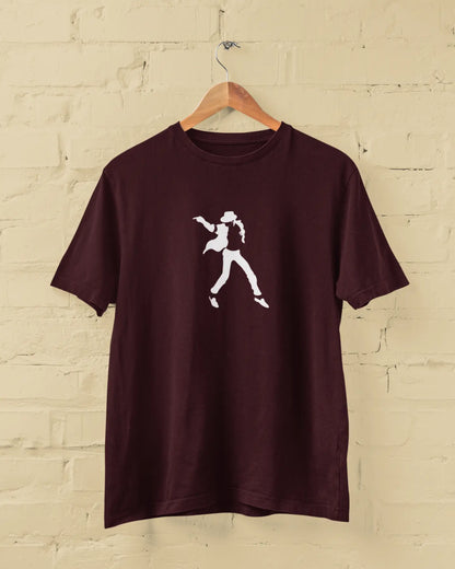 Maroon michael jackson t-shirt with a white graphic on a wooden hanger against a beige brick wall.