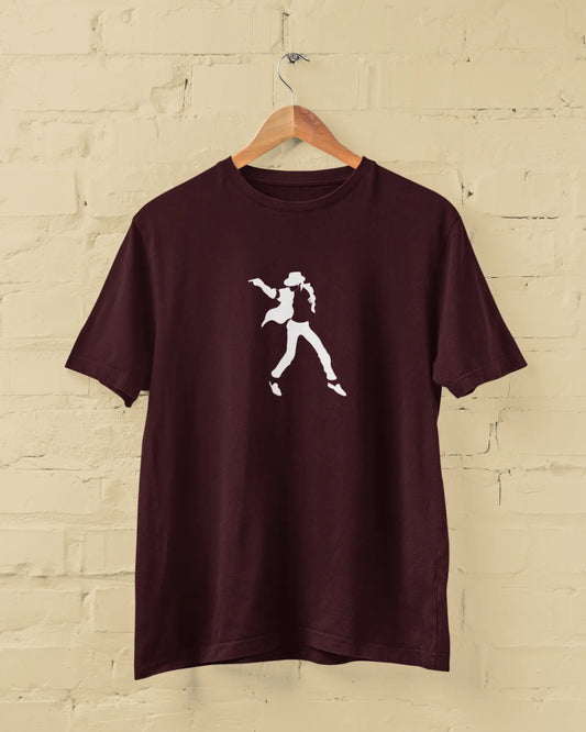 Maroon michael jackson t-shirt with a white graphic on a wooden hanger against a beige brick wall.