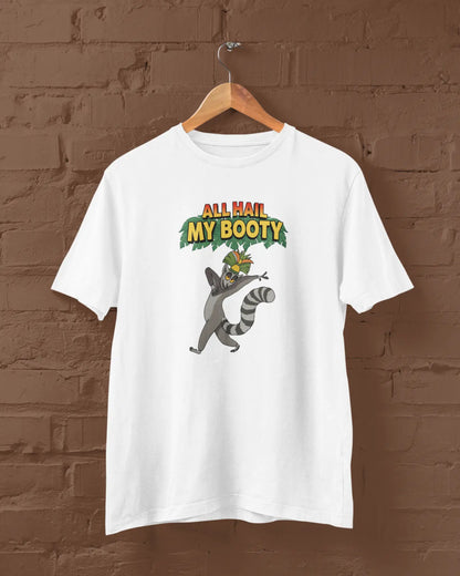 White t-shirt with a raccoon graphic and text 'All Hail My Booty' on a brown brick wall background.